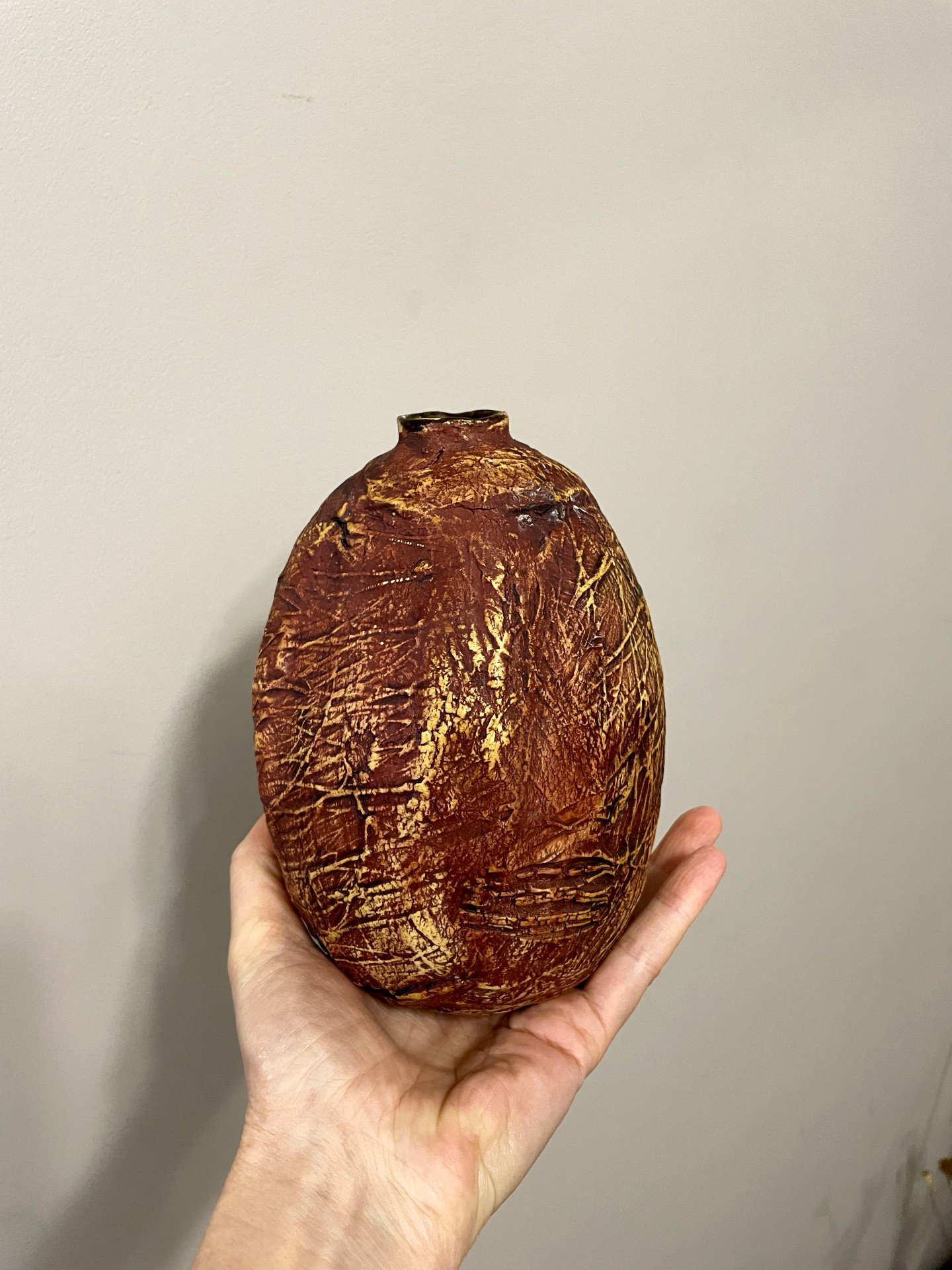 Ceramic vase held in hand to show scale and handmade texture details