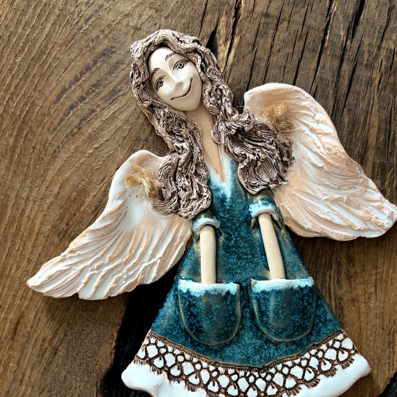 Ceramic angel sculpture in teal dress with feathered wings