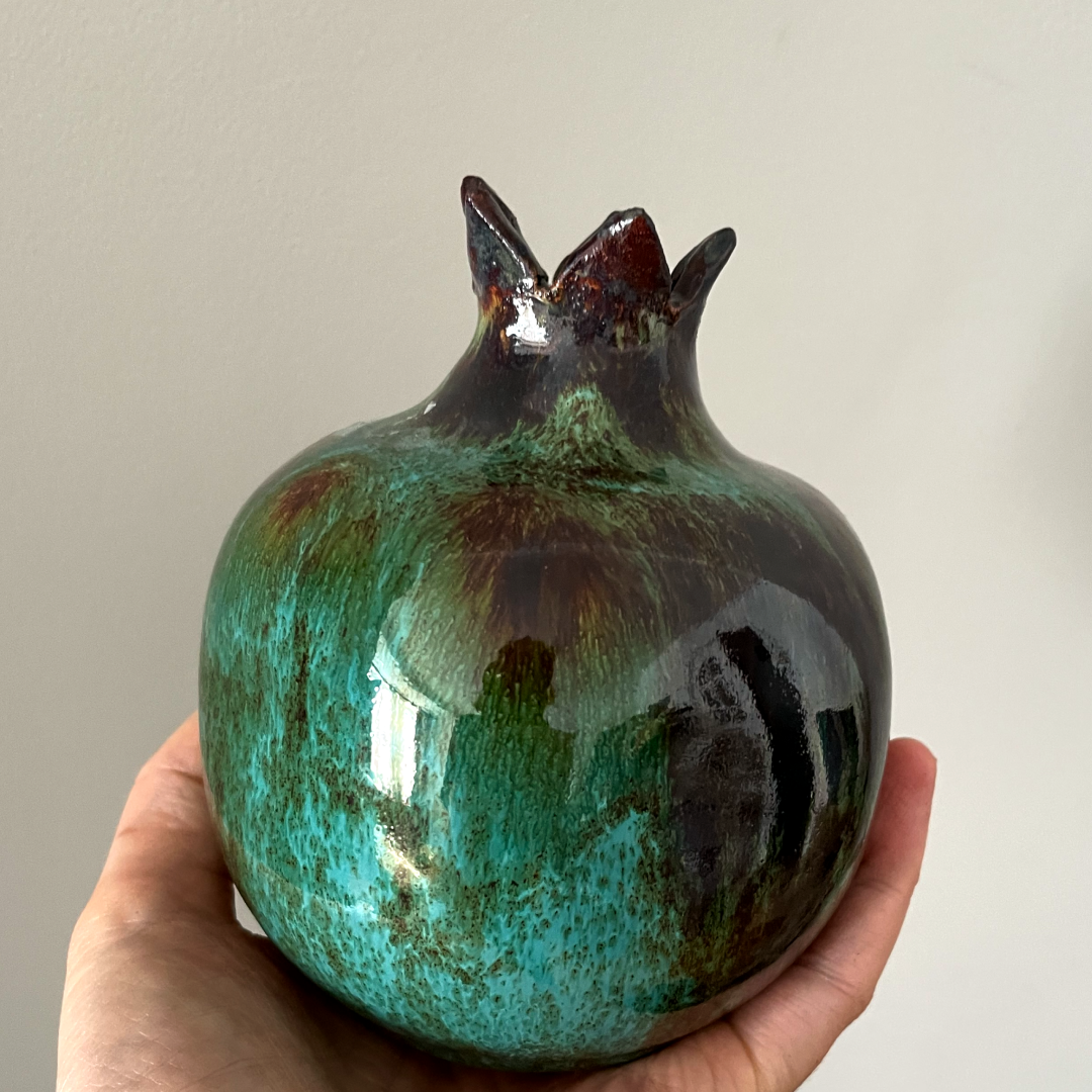 Handmade pottery pomegranate with glossy surface