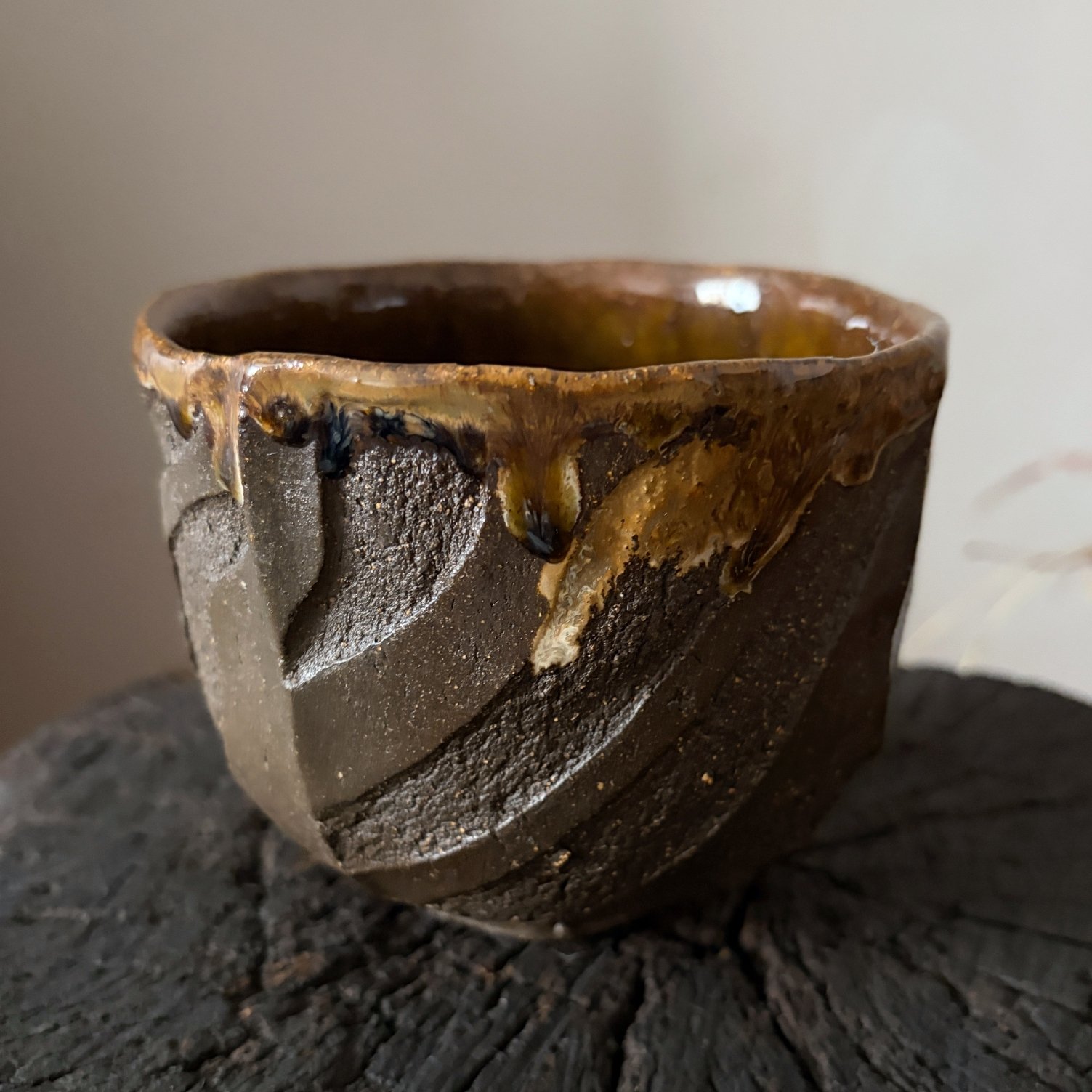 Side view of black clay Kurinuki ceramic chawan