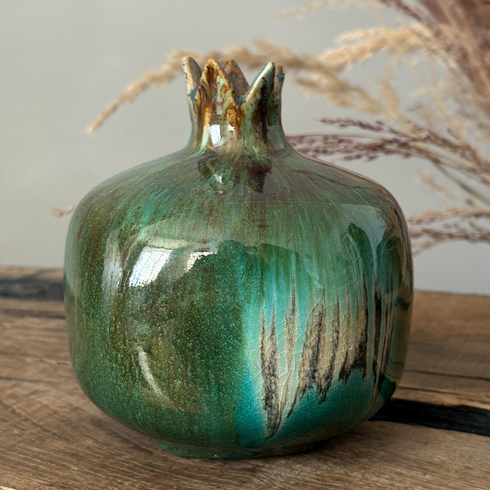 Sculptural ceramic fruit vase with deep green glossy finish