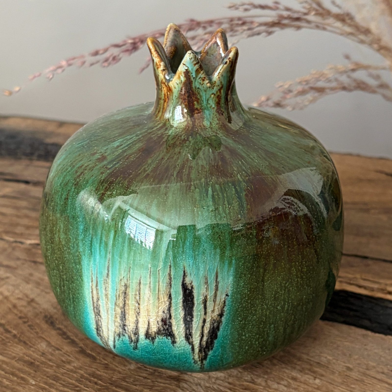 Decorative ceramic pomegranate with rich green and turquoise glaze