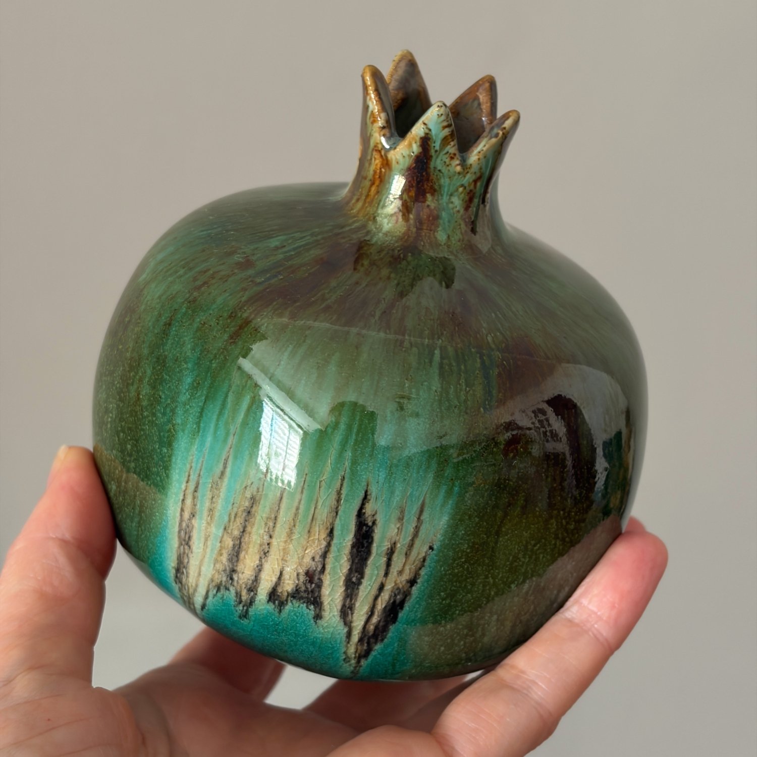 Glazed green pomegranate vase with sculpted crown and handmade surface