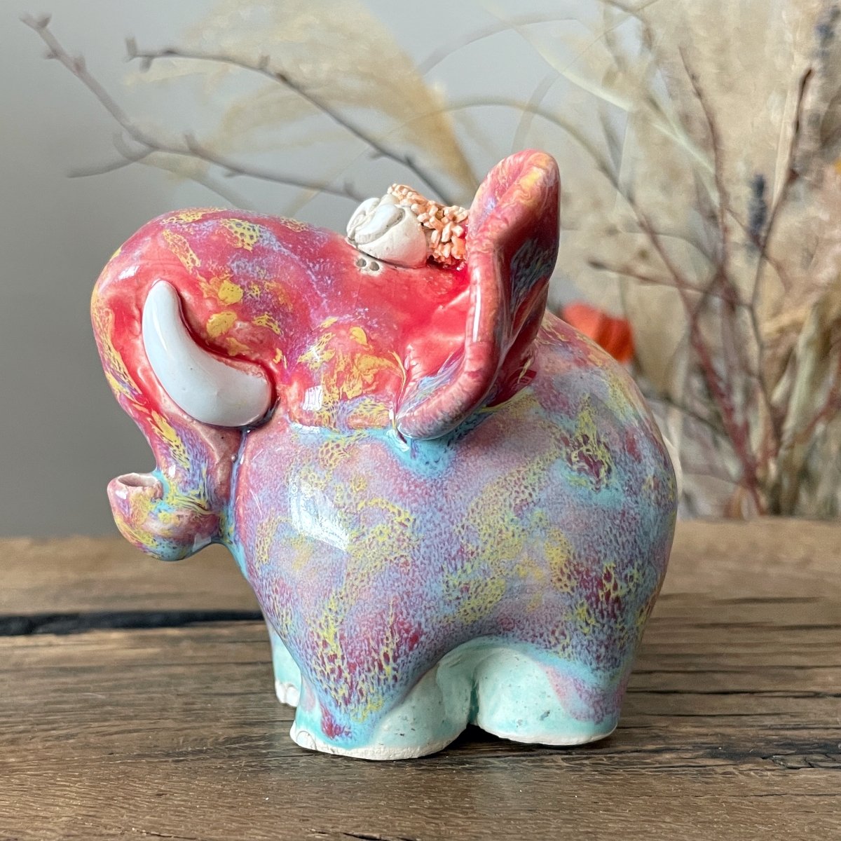 Modern bright ceramic animal sculpture as a decorative accent for wooden home office shelf