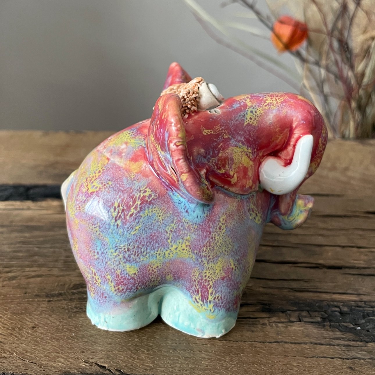 Abstract ceramic elephant decor featuring large colorful ears and textured head detail