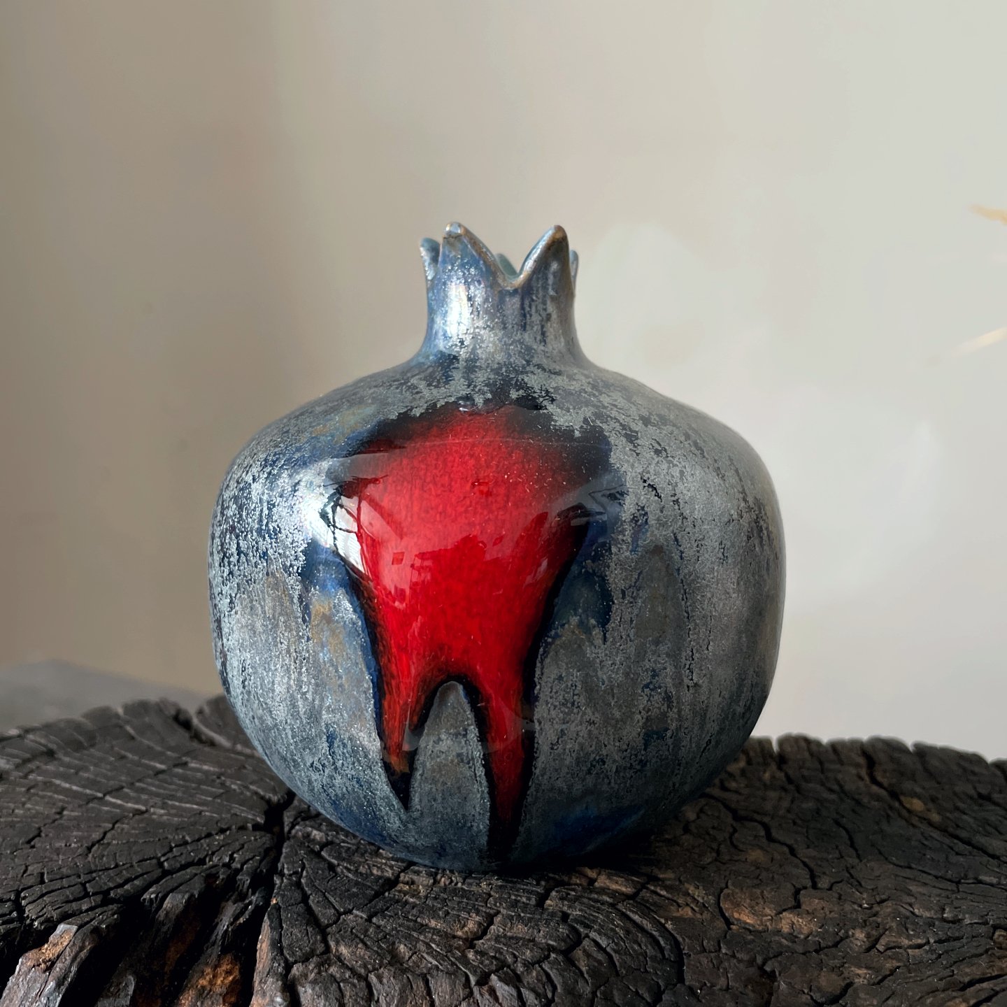 Handmade ceramic pomegranate sculpture with black and red glaze
