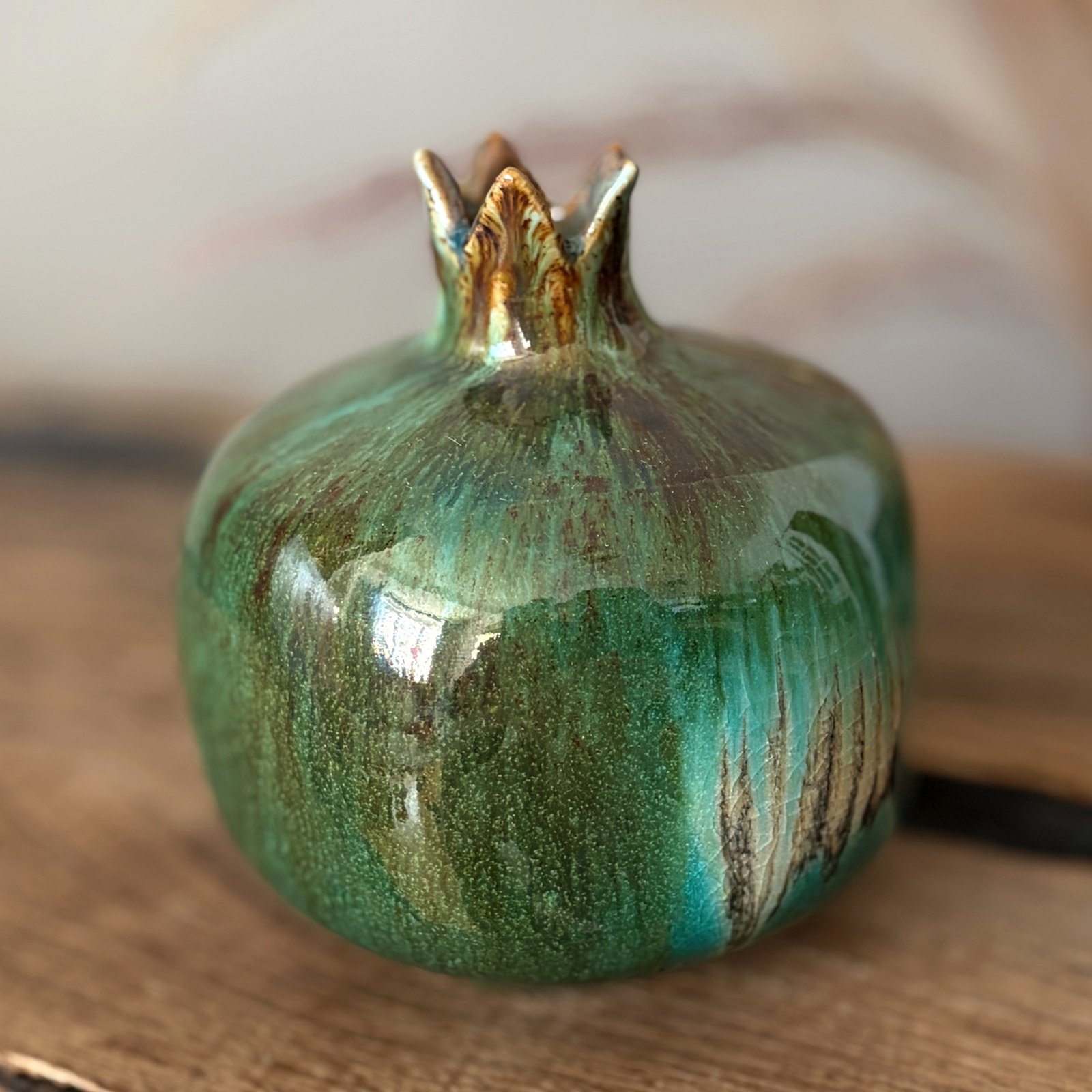 Handmade pottery pomegranate with glossy emerald green finish