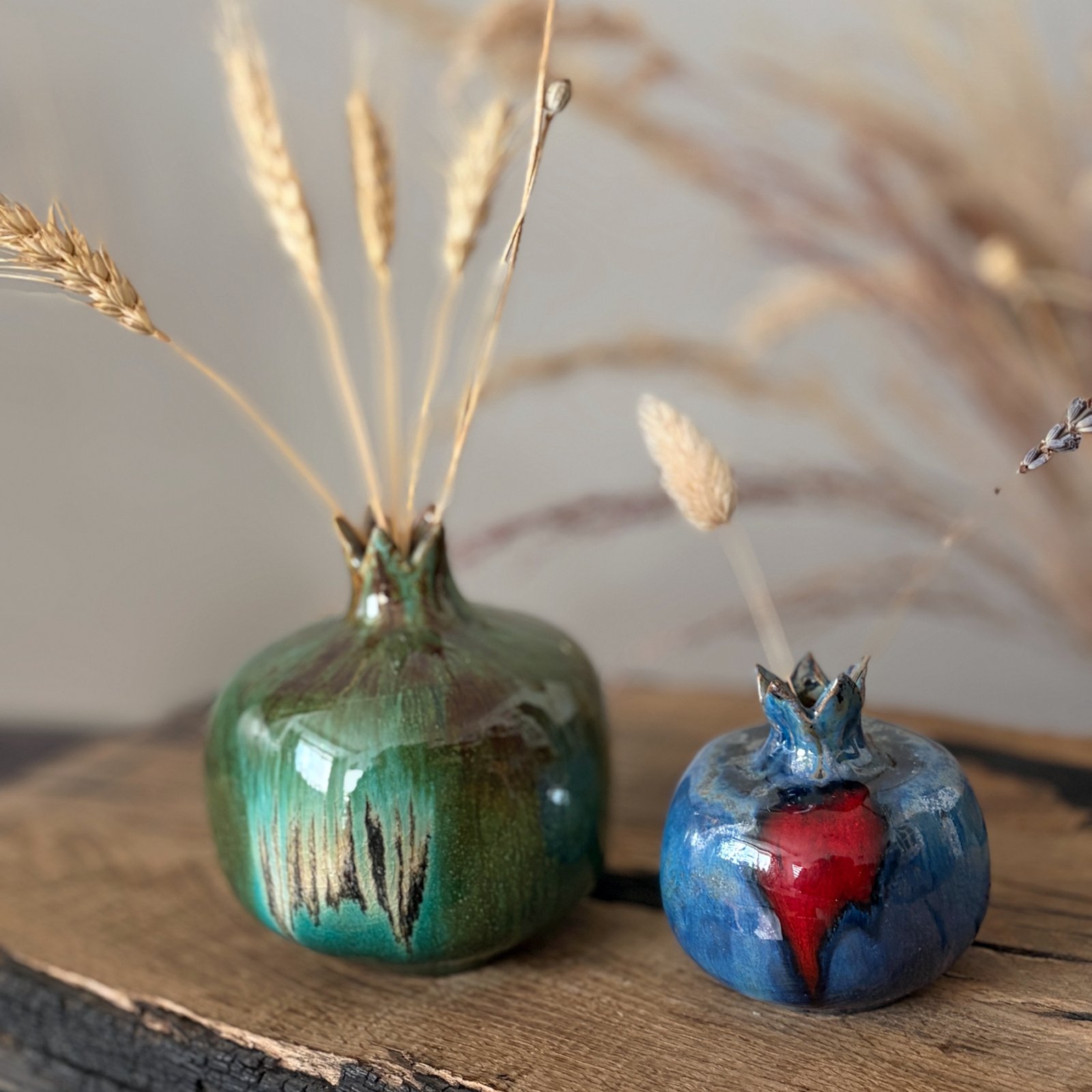 Artisan ceramic pomegranate featuring layered green and blue-green glaze