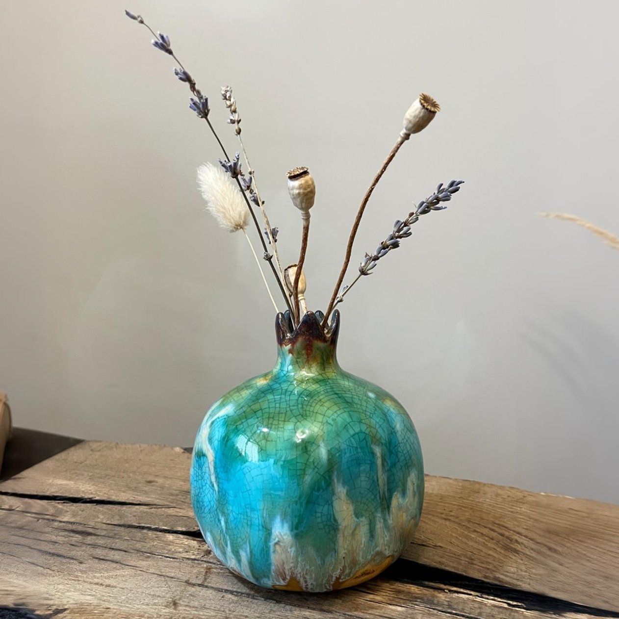 Ceramic pomegranate vase with dried branches arrangement