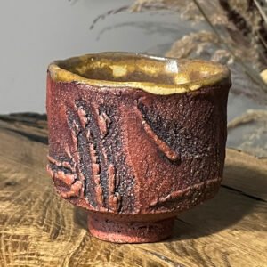Textured kurinuki yunomi cup handmade from red stoneware