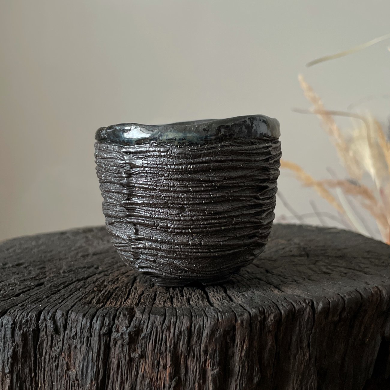 Ceramic yunomi tea cup held in hand for size reference