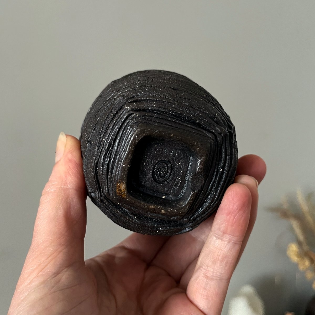 Bottom view of handmade ceramic yunomi showing foot ring