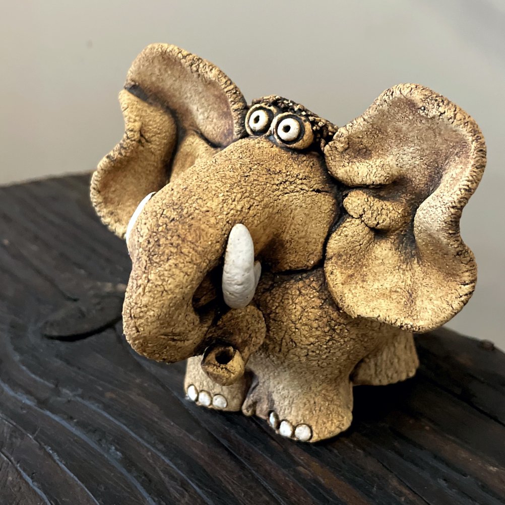 Whimsical ceramic elephant sculpture handmade from white clay