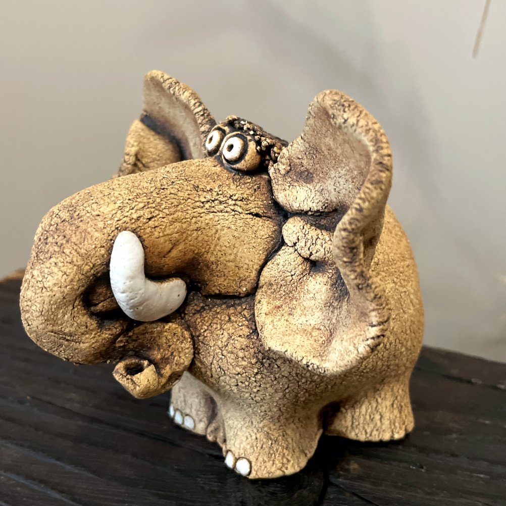 Close-up of whimsical ceramic elephant face with expressive ears