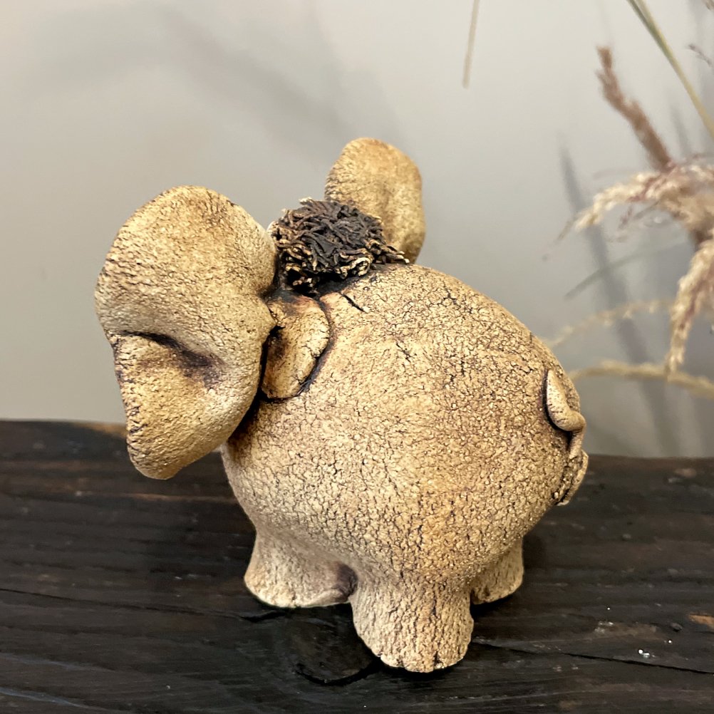 Handmade whimsical ceramic elephant sculpture side view