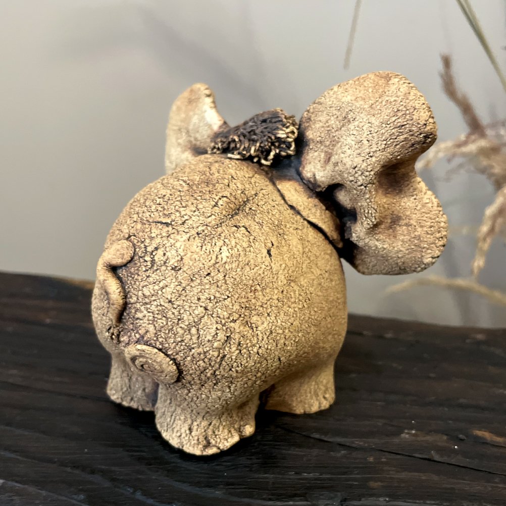 Unique ceramic elephant figurine back view with natural texture