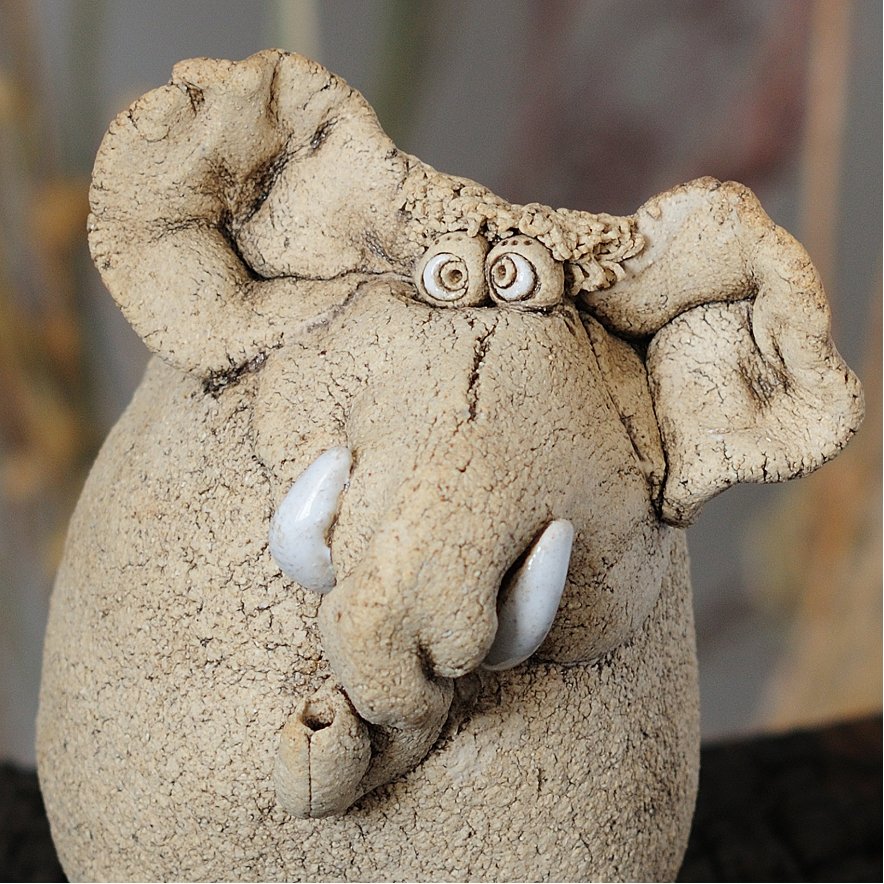 Close-up of expressive ceramic elephant face — quirky handmade detail