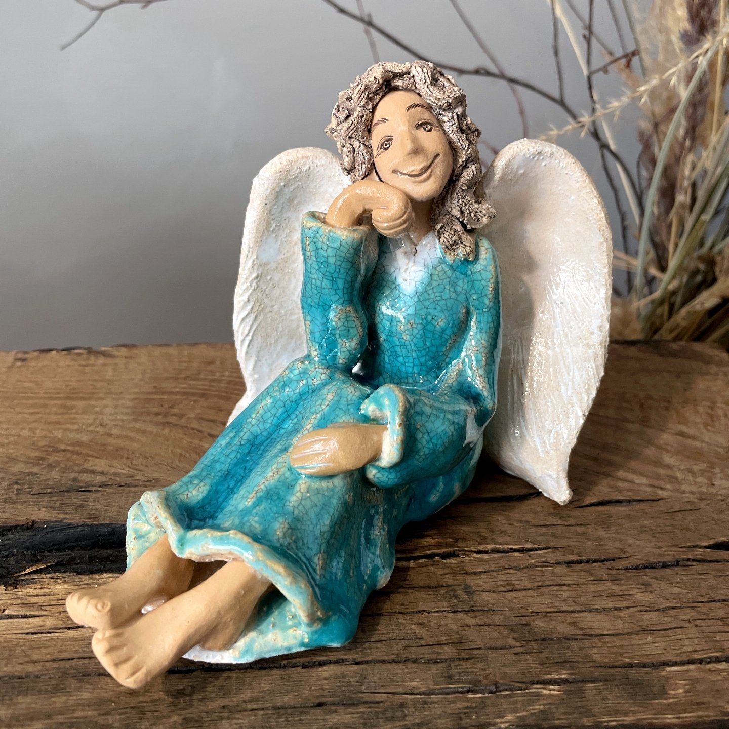 Handmade angel sculpture with turquoise glaze and white wings