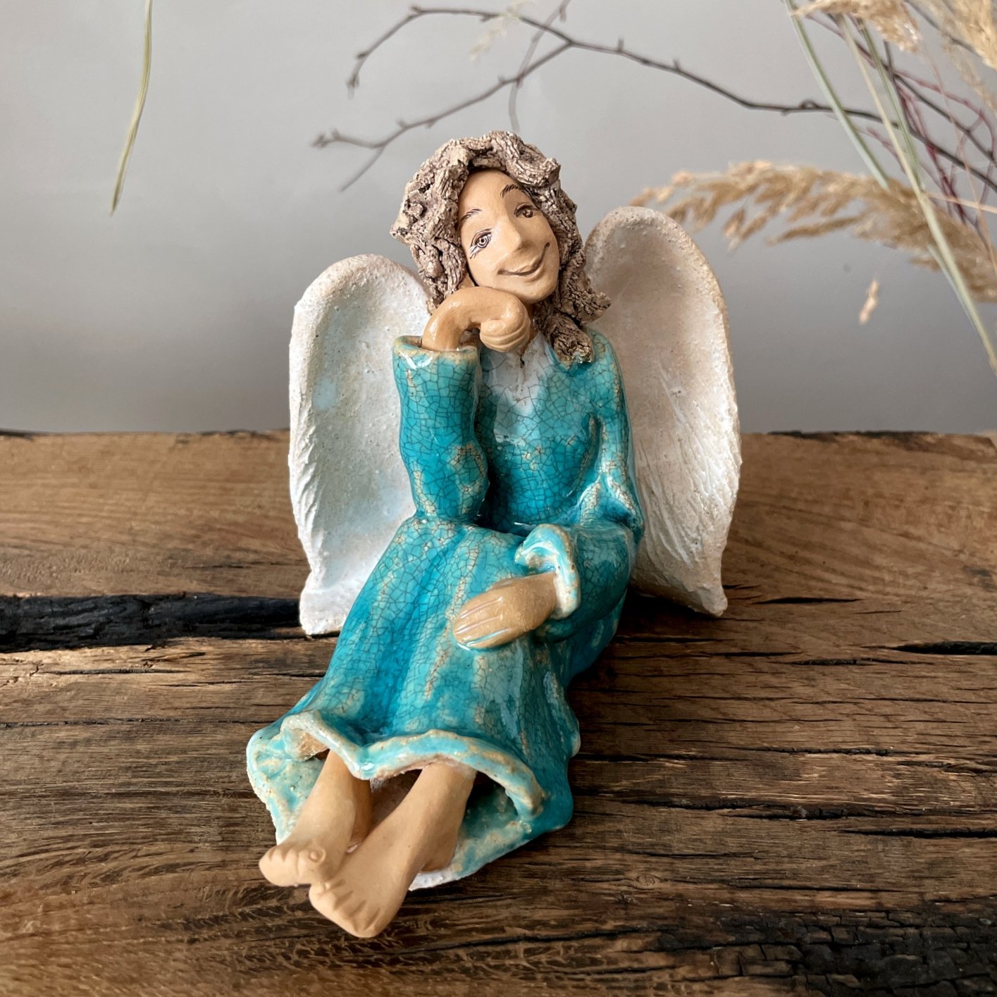 Handcrafted angel figurine sitting with folded hands