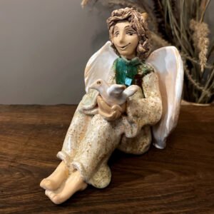 handmade ceramic angel figurine holding a bird