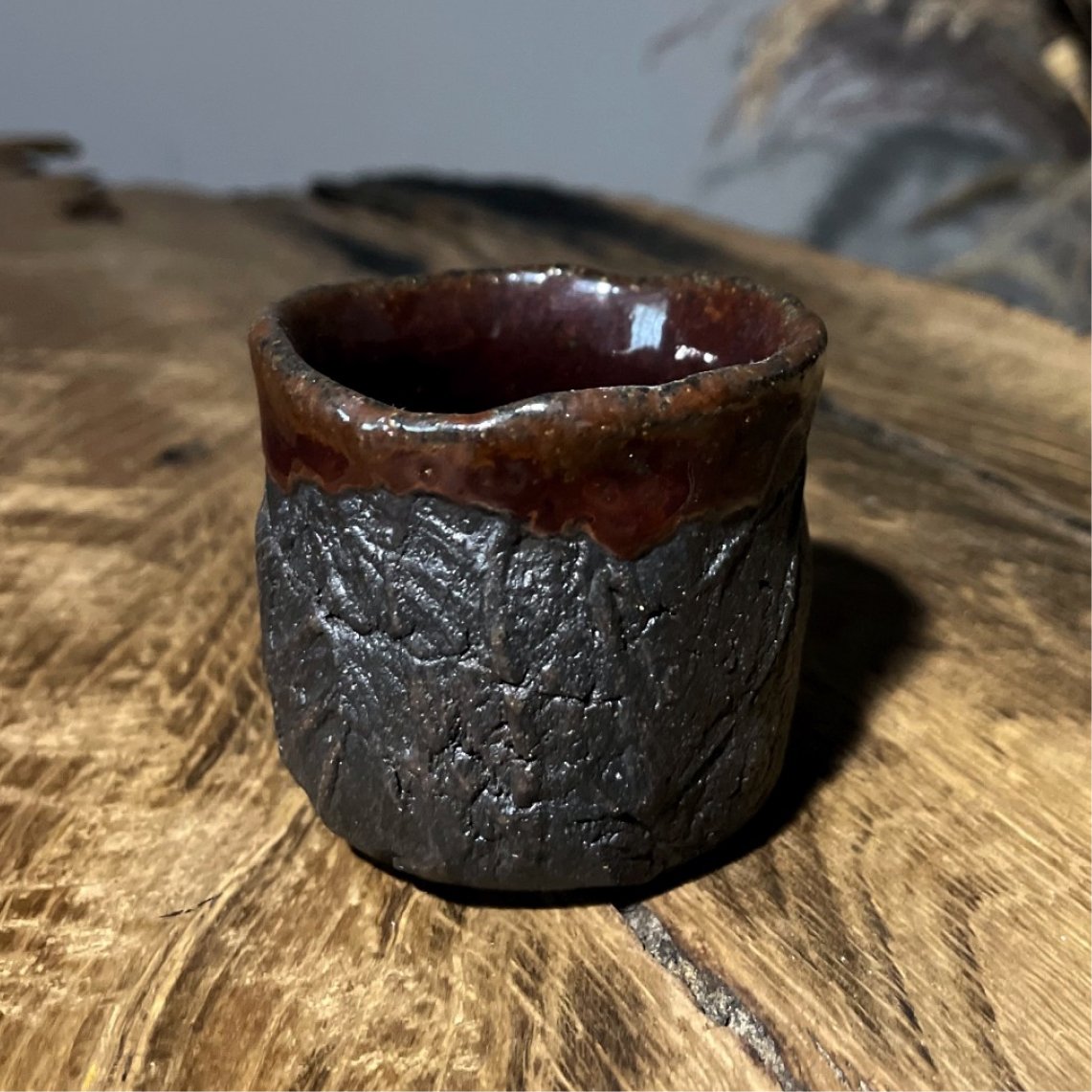 Small black clay ceramic whiskey cup