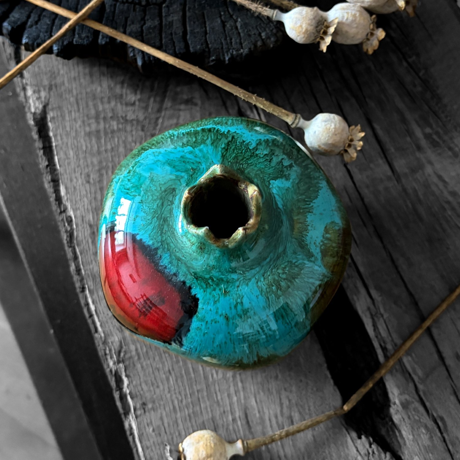 Handmade ceramic pomegranate with turquoise green glaze and red accents