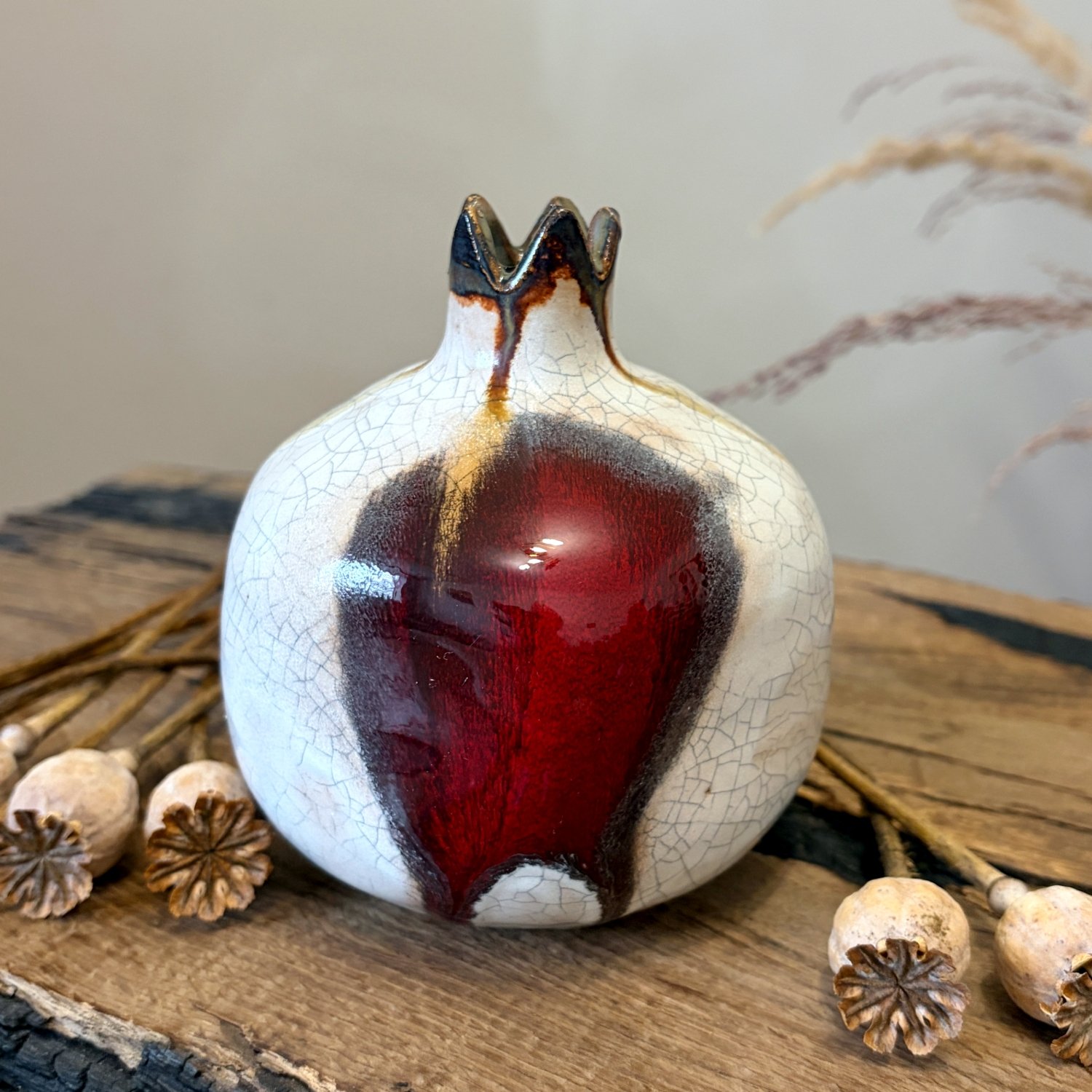 White pottery pomegranate with burgundy glaze and handmade textured surface