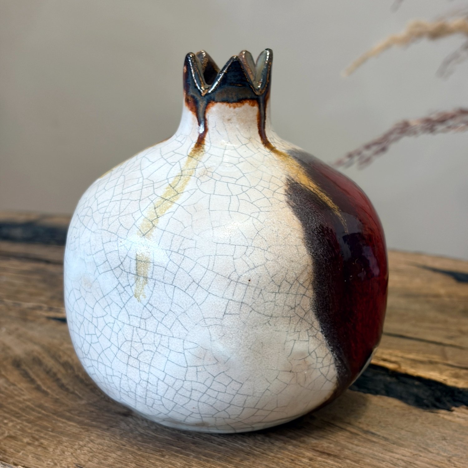 Handmade pomegranate figurine with contrasting white and wine red finish