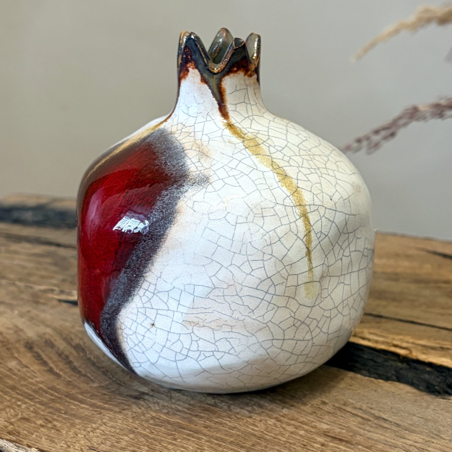Artisan pomegranate sculpture with white crackle glaze and burgundy detail