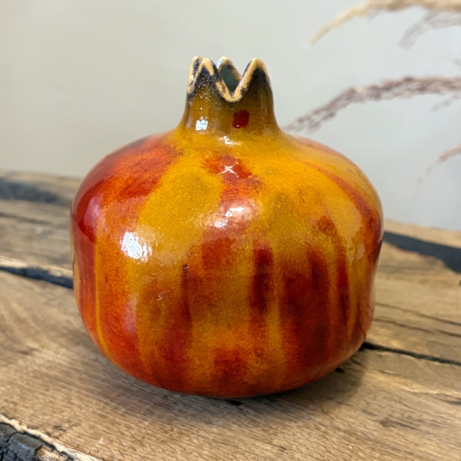 Handmade ceramic pomegranate with sculpted crown and multicolored glaze