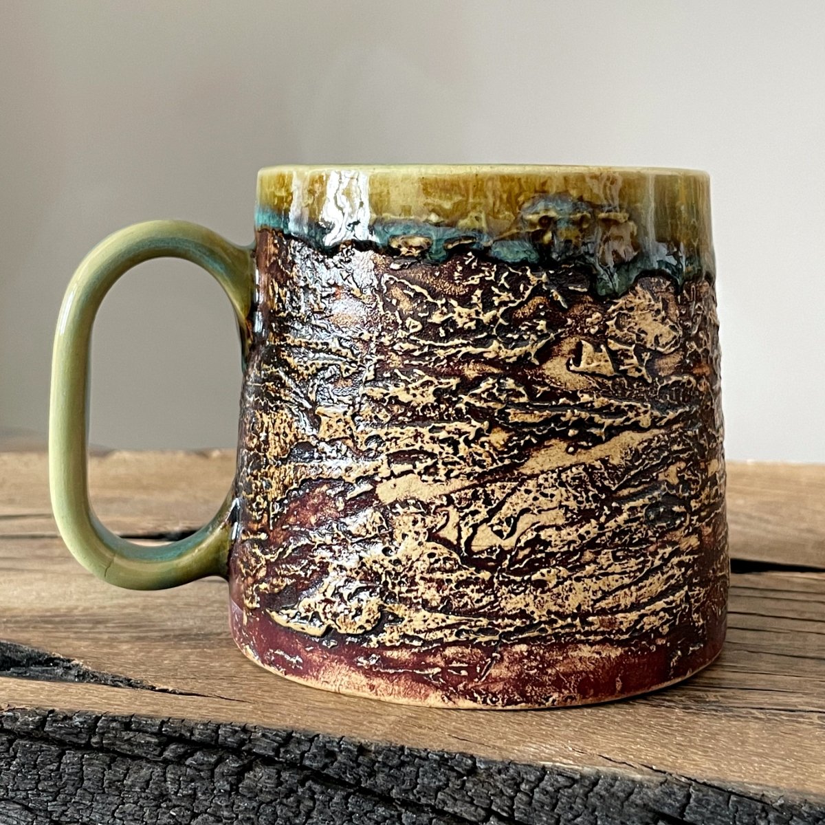 Textured pottery mug for coffee or tea with glazed interior