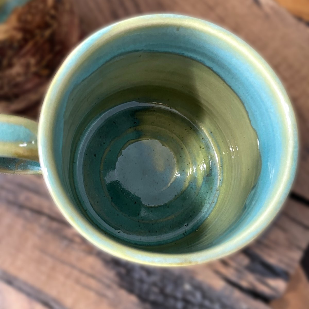 Stoneware mug with rich brown texture and soft green blue glaze