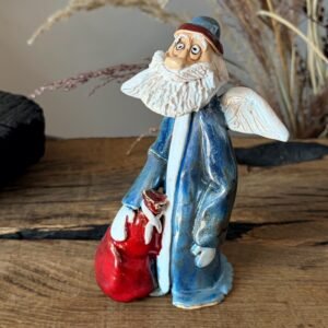Handmade ceramic Christmas figurine with blue robe and red bag
